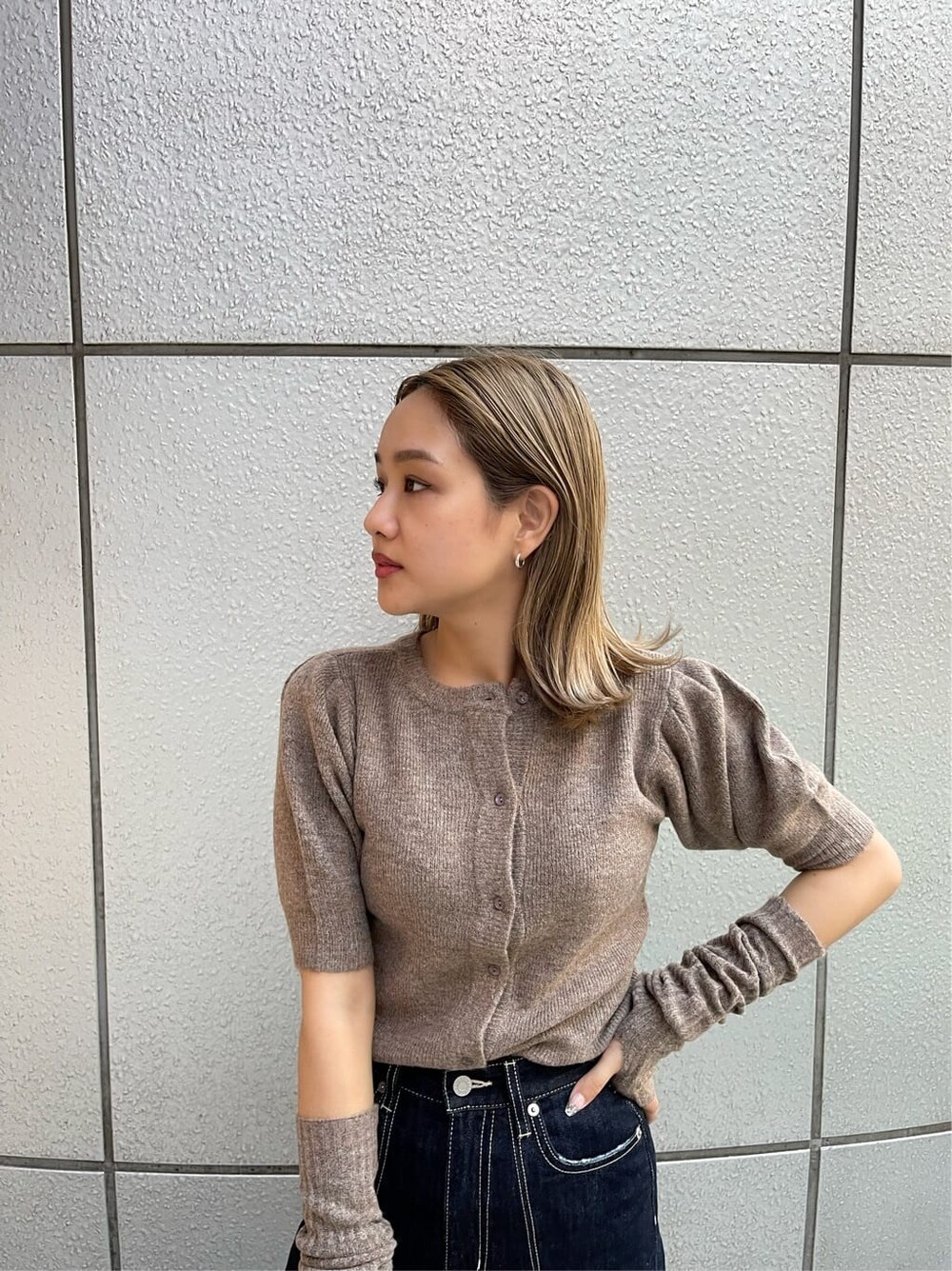 ブラック系のスリッポン、ブラック系のボストンバッグ、ブルー系のデニムパンツを着用したレディースの夏コーディネートの7枚目の写真