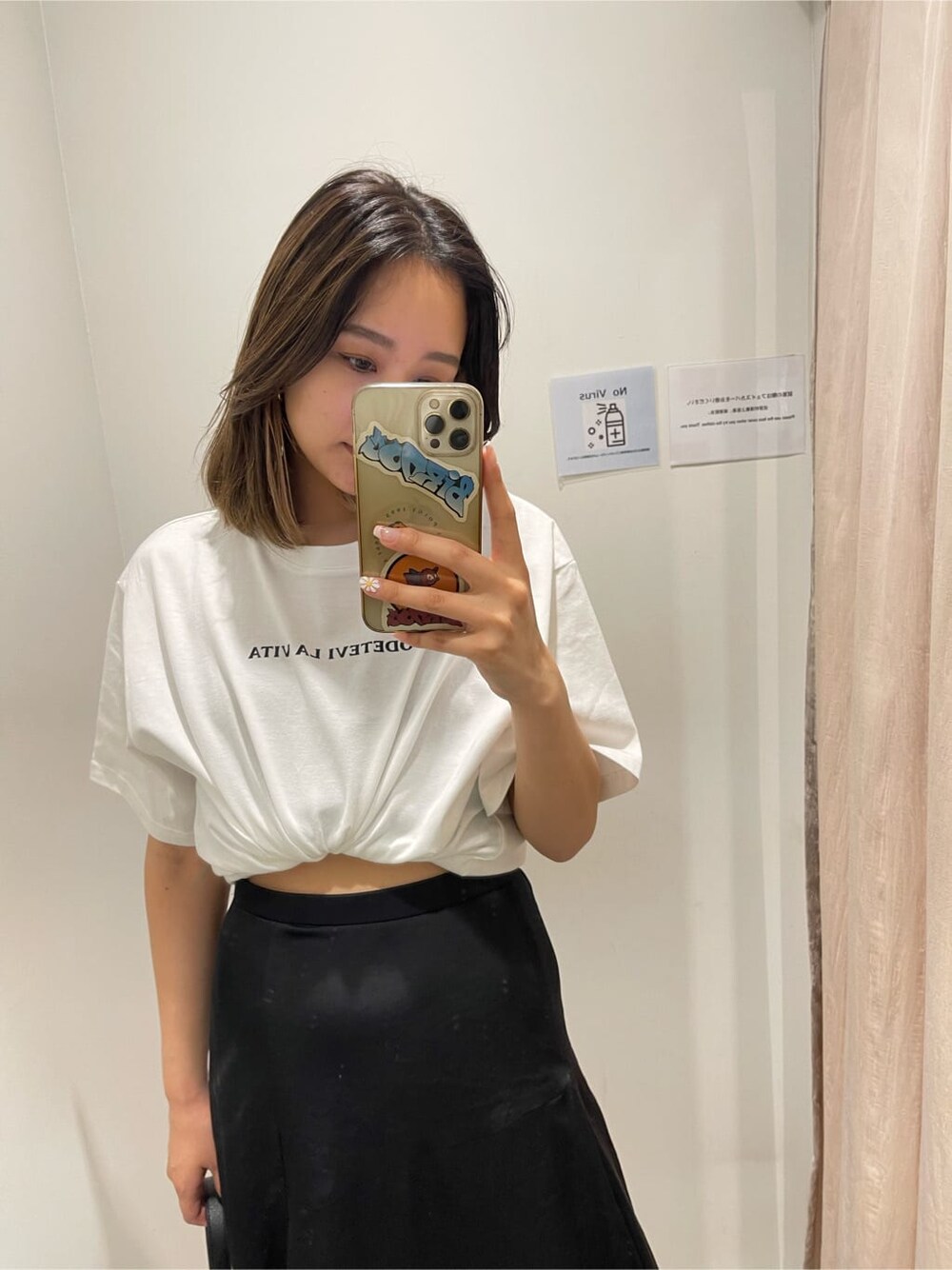 ブラック系のショルダーバッグ、ホワイト系のTシャツ/カットソー、ブラック系のスカートを着用したレディースの春コーディネートの4枚目の写真