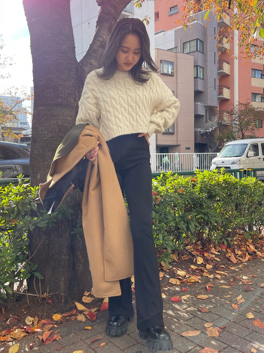 ブラック系のその他パンツ、その他のブーツ、ベージュ系のトレンチコートを着用したレディースの秋コーディネートの8枚目の写真