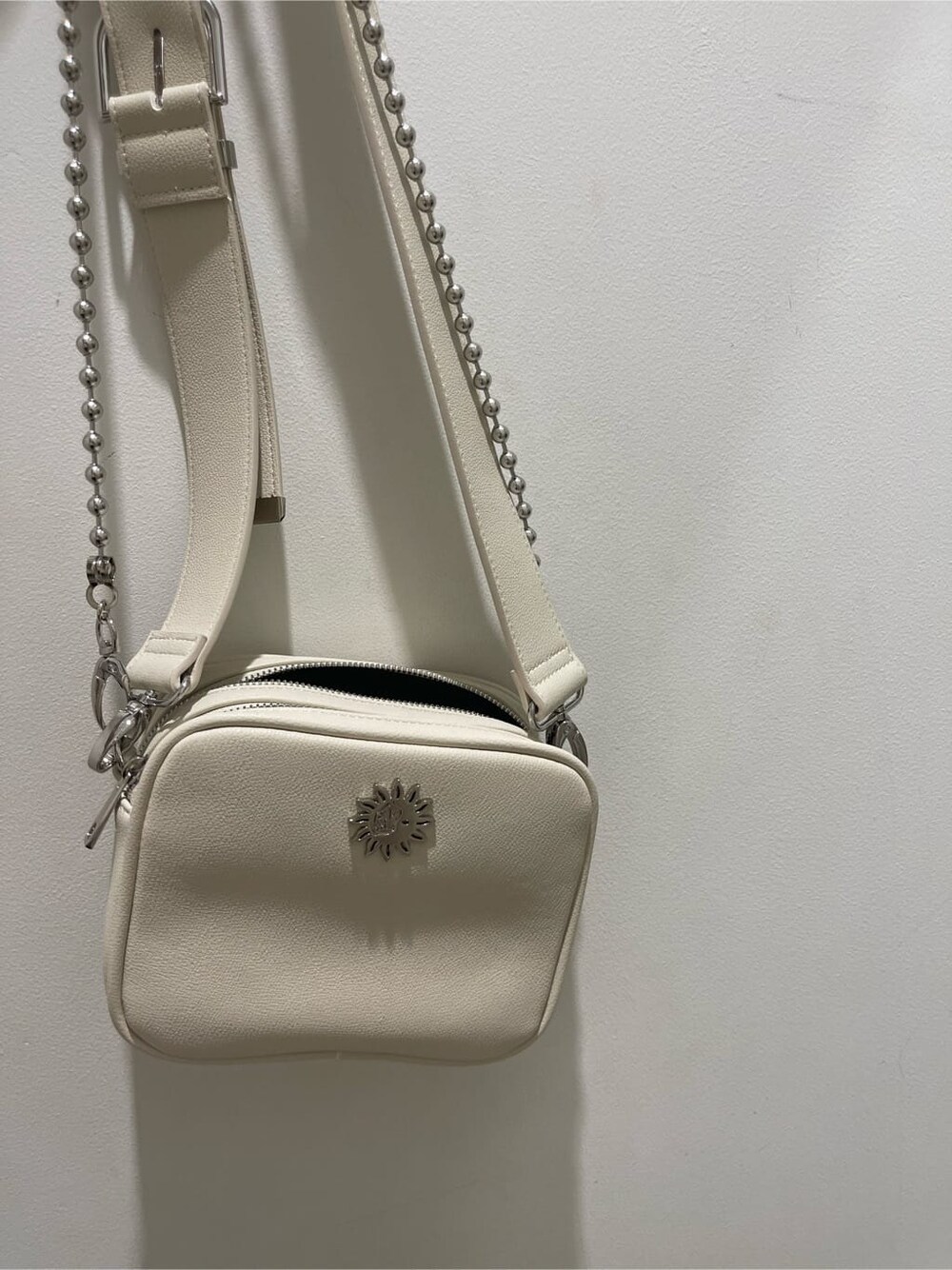 ブラック系のサンダル、ベージュ系のTシャツ/カットソー、ホワイト系のショルダーバッグを着用したレディースの春コーディネートの5枚目の写真