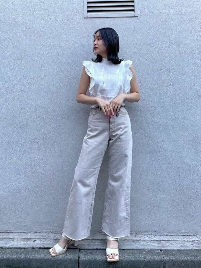 ホワイト系のシャツ/ブラウス、ベージュ系のデニムパンツ、ホワイト系のサンダルを着用したレディースの春コーディネートの2枚目の写真