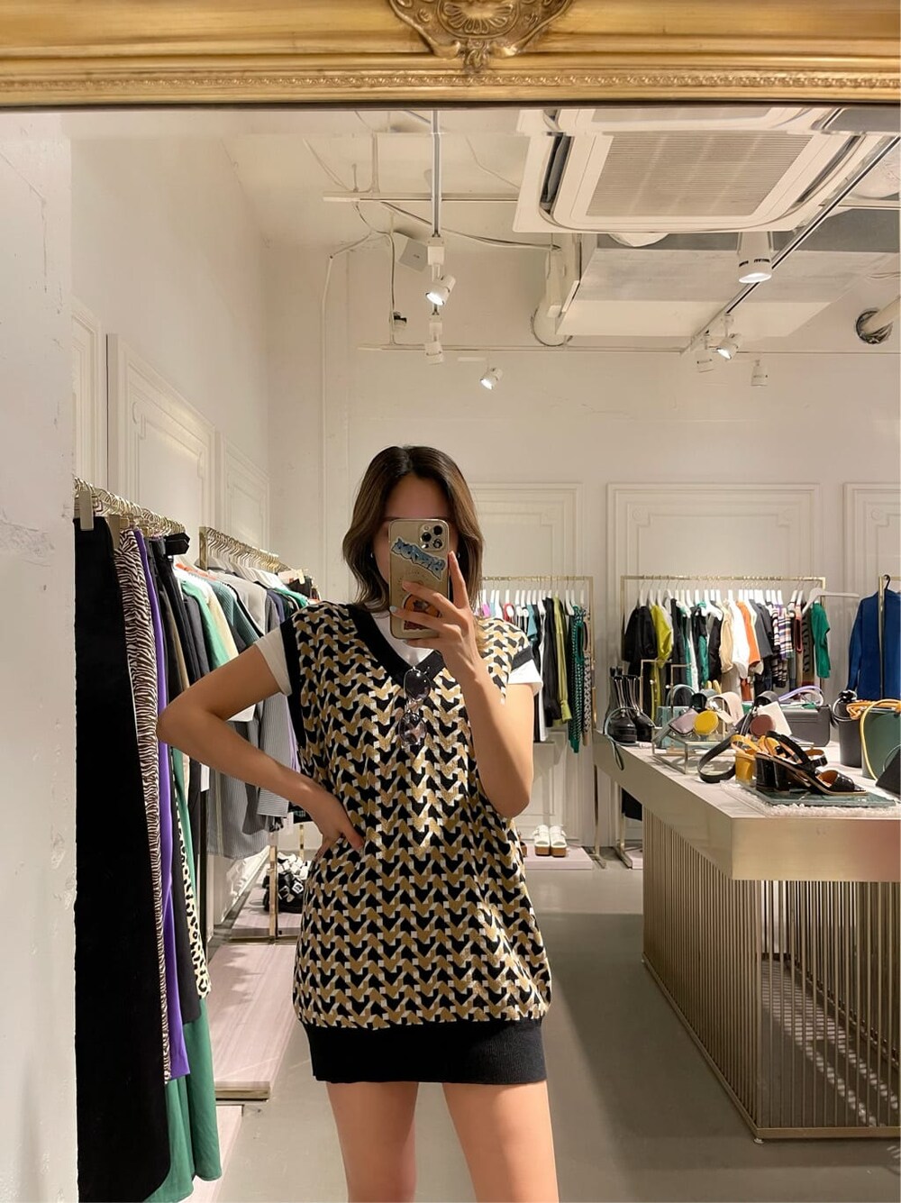 ブラック系のブーツ、ベージュ系のデニムパンツ、ブラック系のニット/セーターを着用したレディースの春コーディネートの4枚目の写真