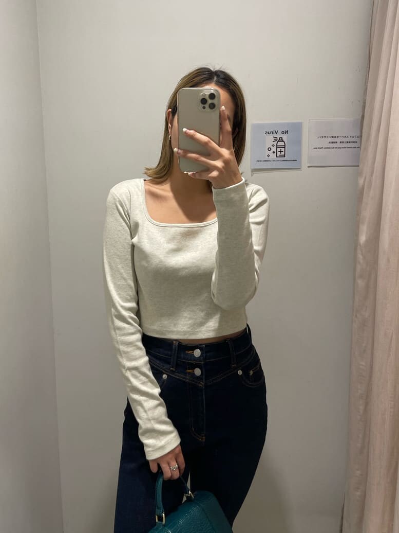 ブルー系のデニムパンツ、グレー系のTシャツ/カットソー、ホワイト系のスニーカーを着用したレディースの秋コーディネートの2枚目の写真