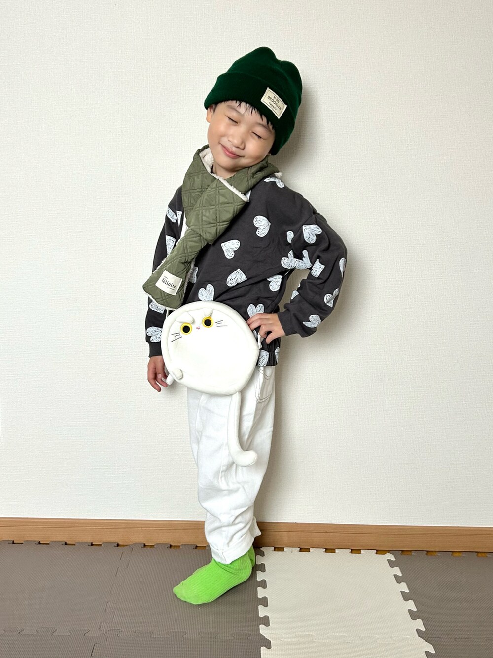 ホワイト系のデニムパンツ、グレー系のスウェット、ホワイト系のショルダーバッグを着用したキッズの秋コーディネートの4枚目の写真