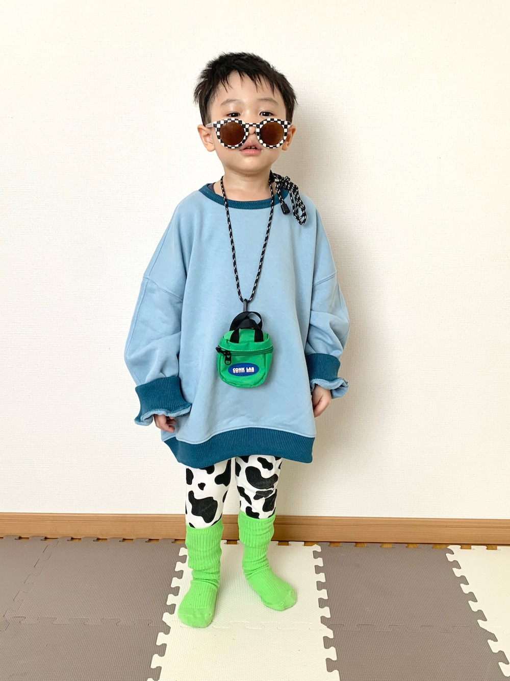 ブルー系のスウェット、グリーン系のバッグ、ホワイト系のその他パンツを着用したキッズの春コーディネートの3枚目の写真