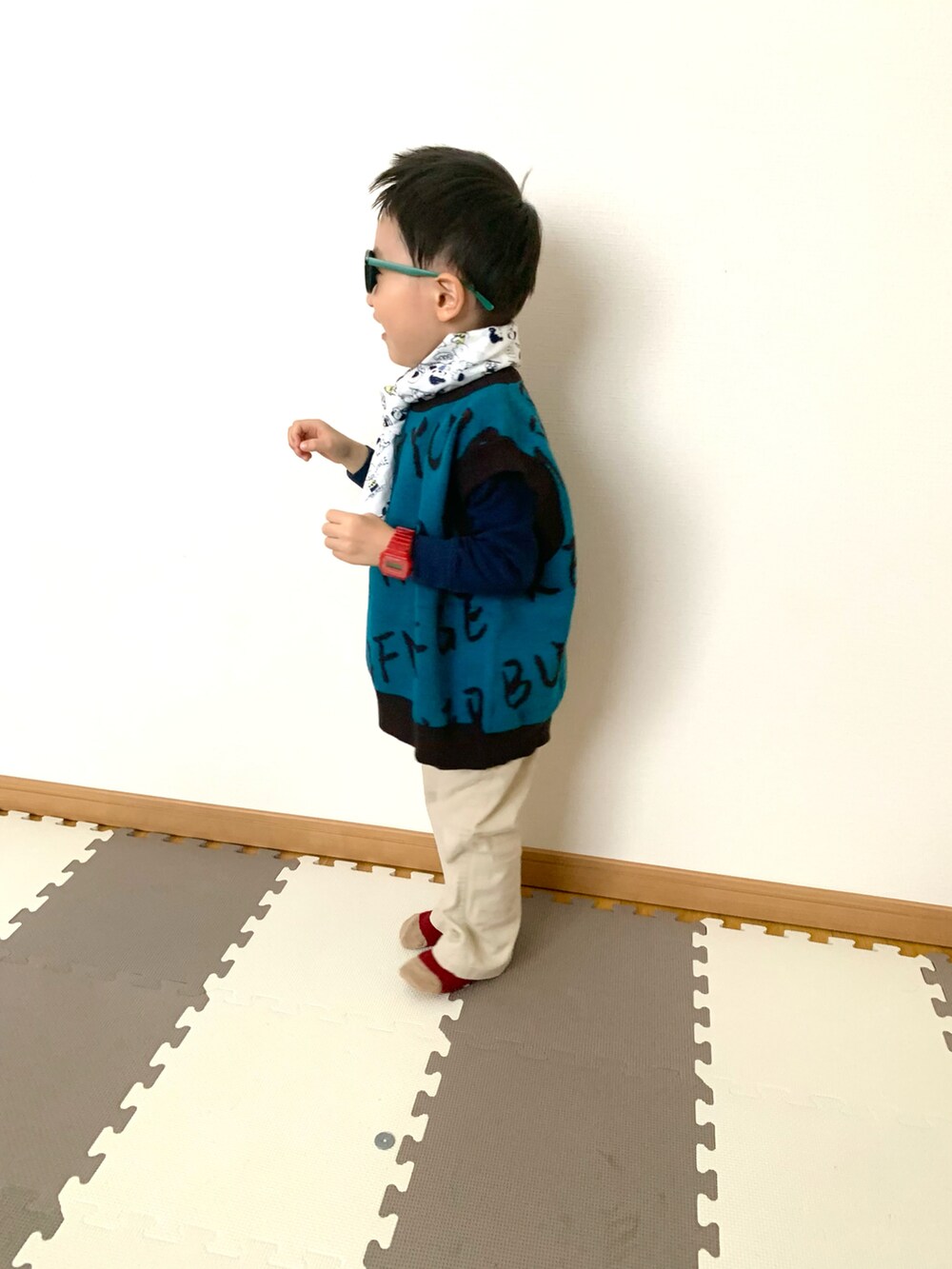 ブルー系のベスト、ブルー系のスウェット、ベージュ系のチノパンツを着用したキッズの冬コーディネートの4枚目の写真