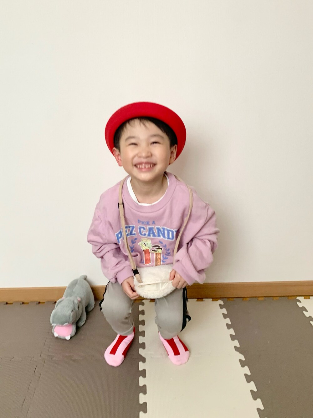 グレー系のその他パンツ、ピンク系のスウェット、ホワイト系のショルダーバッグを着用したキッズの春コーディネートの2枚目の写真