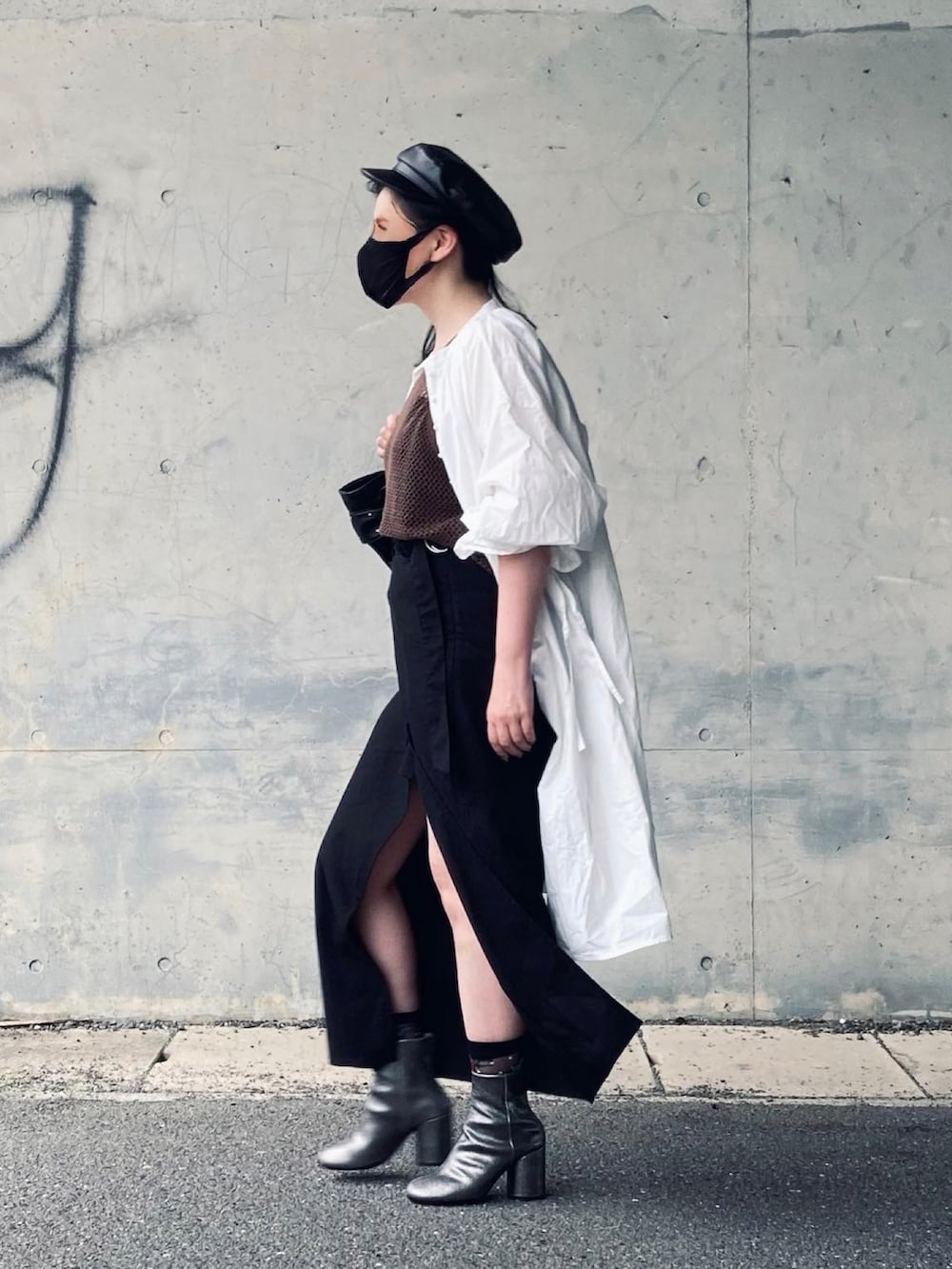 ブラウン系のタンクトップ、ブラック系のスカート、シルバー系のブーツを着用したレディースの夏コーディネートの3枚目の写真