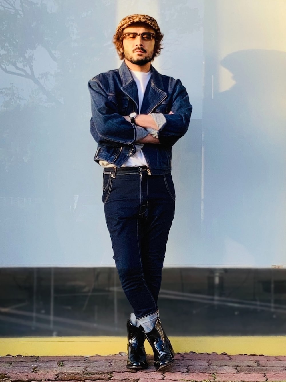 ブルー系のライダースジャケット、ブルー系のデニムパンツ、ブラック系のブーツを着用したメンズの秋コーディネートの3枚目の写真