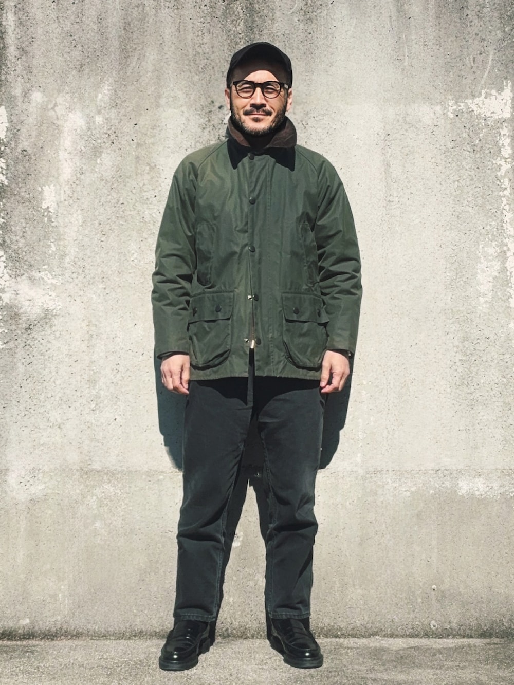 グリーン系のその他アウター、ブラック系のローファー、ブラック系のスウェットを着用したメンズの春コーディネートの2枚目の写真