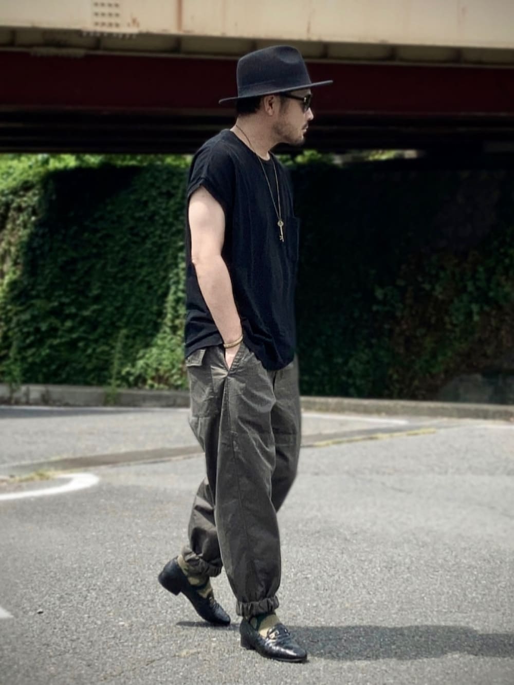 ブラック系のその他トップス、グリーン系のその他パンツ、ブラック系のローファーを着用したメンズの夏コーディネートの2枚目の写真