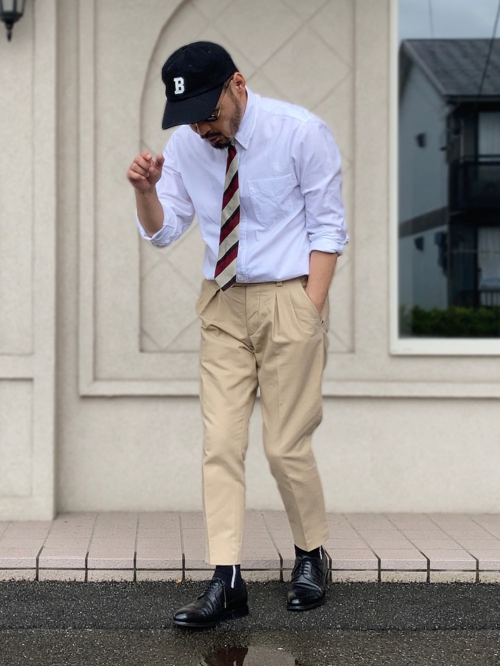 ホワイト系のシャツ/ブラウス、ベージュ系のスラックス、ブラック系のドレスシューズを着用したメンズの夏コーディネートの3枚目の写真