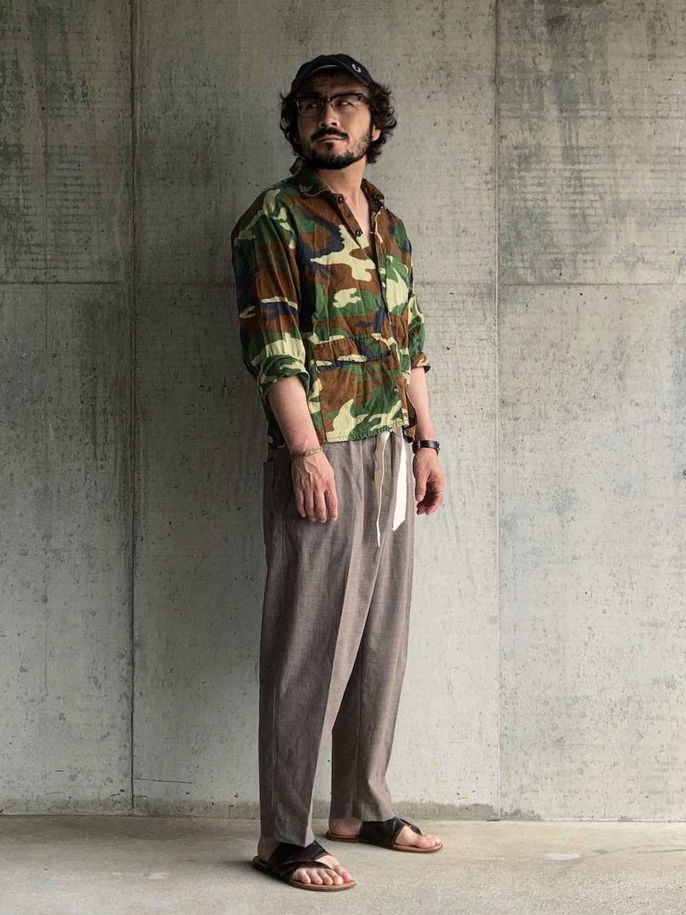 グリーン系のシャツ/ブラウス、ブラウン系のスラックス、ブラウン系のサンダルを着用したメンズの夏コーディネートの2枚目の写真