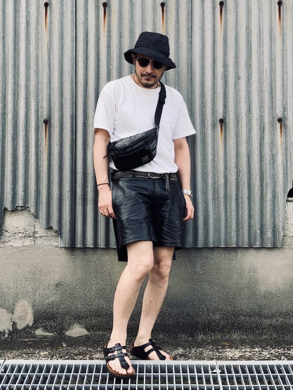 ホワイト系のTシャツ/カットソー、ブラック系のその他パンツ、ブラック系のサンダルを着用したメンズの夏コーディネートの3枚目の写真