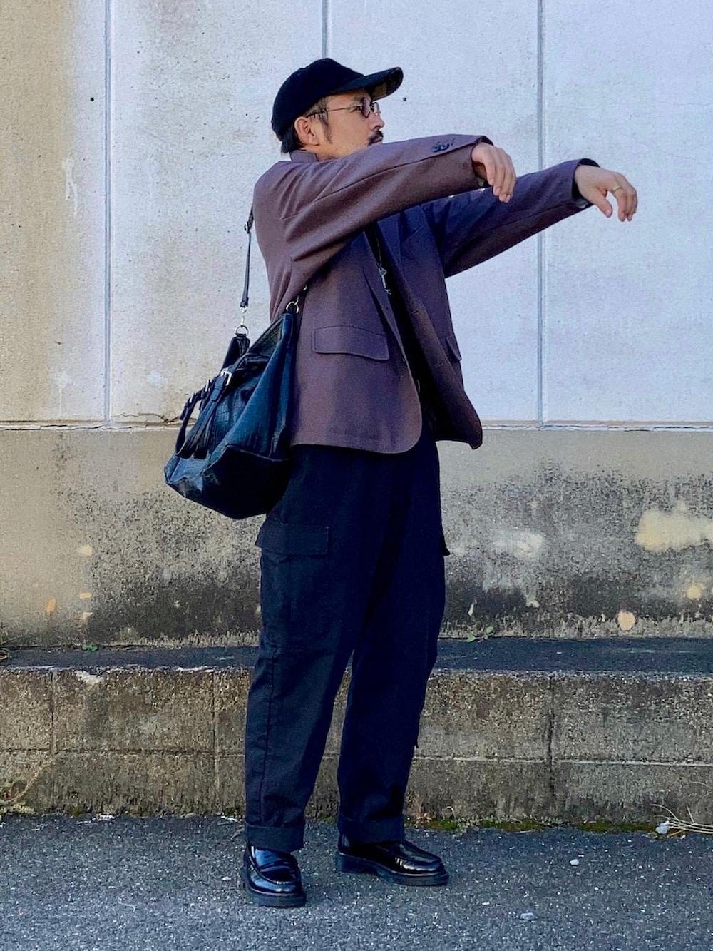 ブラック系のニット/セーター、グレー系のセットアップ、ブラック系のカーゴパンツを着用したメンズの秋コーディネートの2枚目の写真