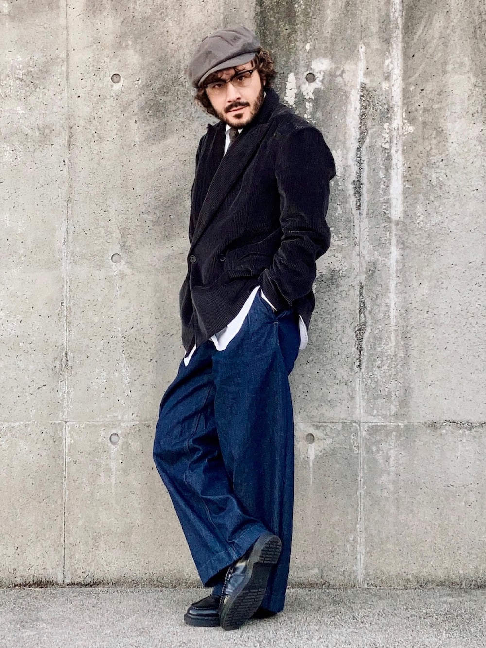 グレー系のテーラードジャケット、ブルー系のデニムパンツ、ブラック系のローファーを着用したメンズの秋コーディネートの3枚目の写真