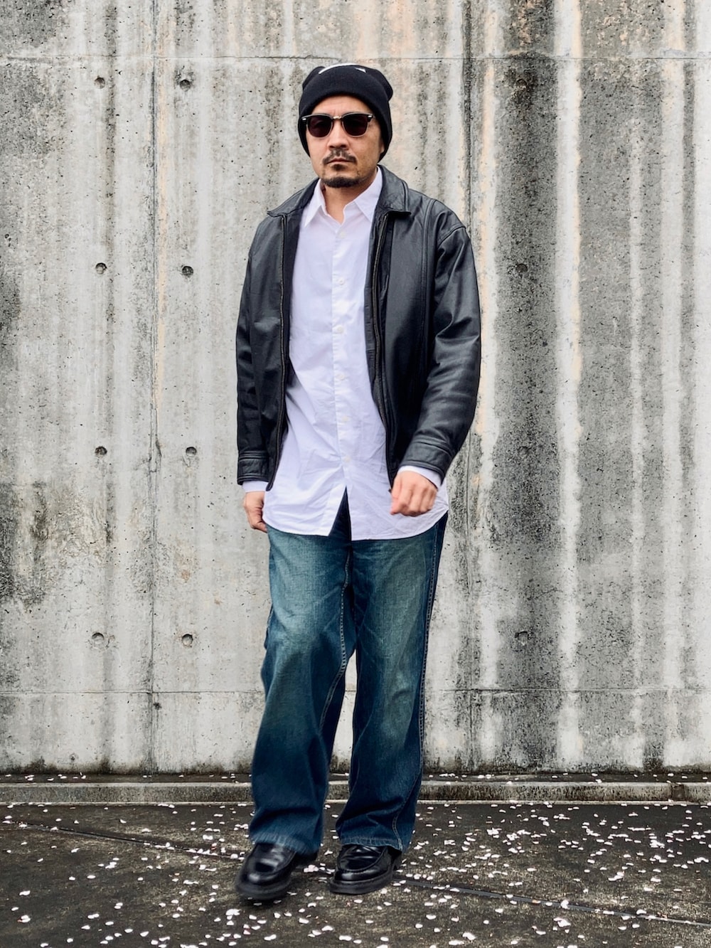 ホワイト系のシャツ/ブラウス、ブラック系のブルゾン、ブルー系のデニムパンツを着用したメンズの春コーディネートの4枚目の写真