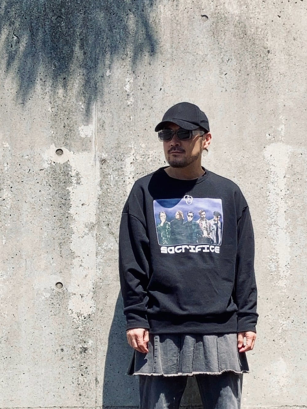 ブラック系のスウェット、グレー系のデニムパンツ、ブラック系のブーツを着用したメンズの春コーディネートの3枚目の写真