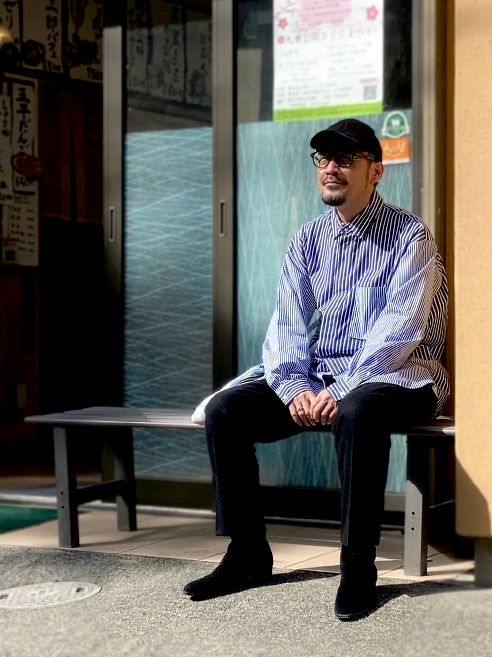 ブルー系のシャツ/ブラウス、ブラック系のスラックス、ブラック系のブーツを着用したメンズの春コーディネートの3枚目の写真