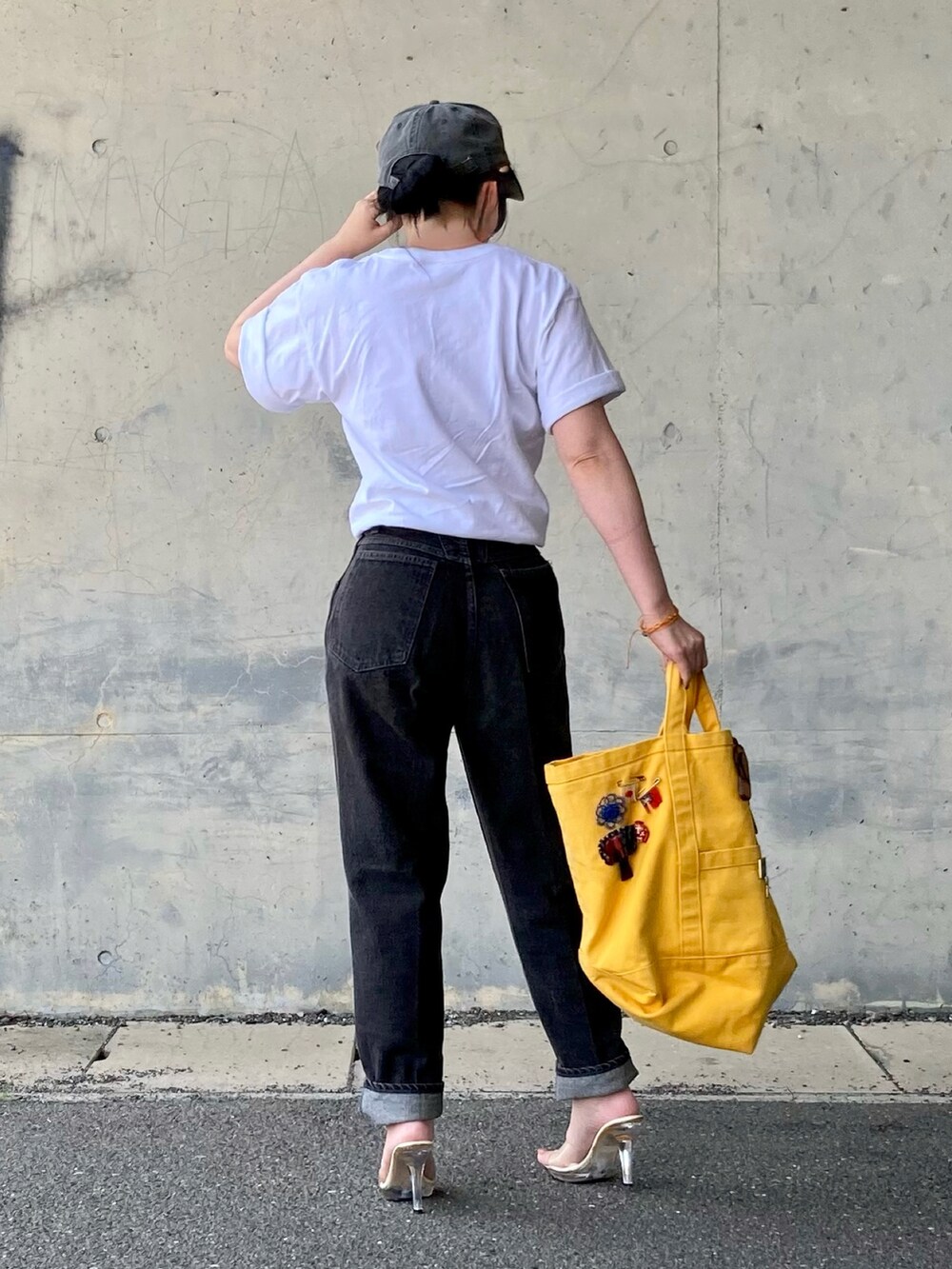 ホワイト系のTシャツ/カットソー、ブラック系のデニムパンツを着用したレディースの春コーディネートの4枚目の写真