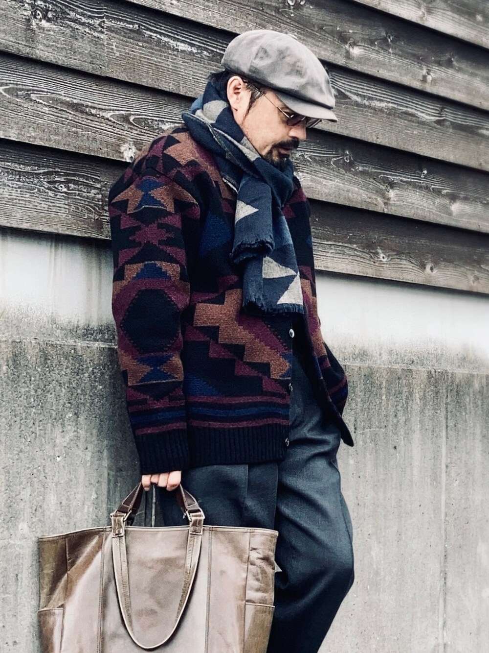 ブラック系のカーディガン/ボレロ、グレー系のスラックス、ブラック系のローファーを着用したメンズの冬コーディネートの5枚目の写真