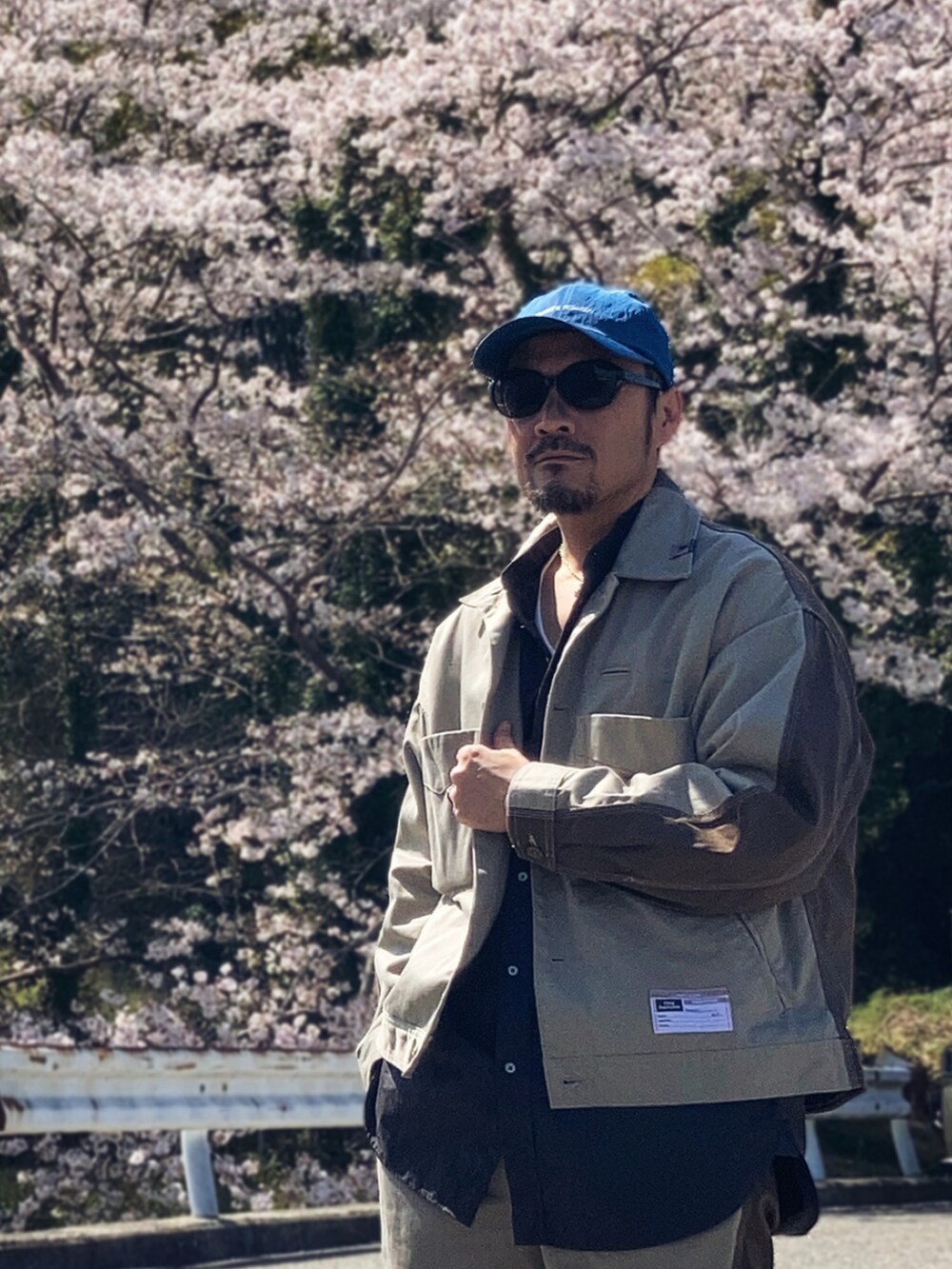 グレー系のシャツ/ブラウス、ベージュ系のその他アウター、ベージュ系のチノパンツを着用したメンズの春コーディネートの3枚目の写真