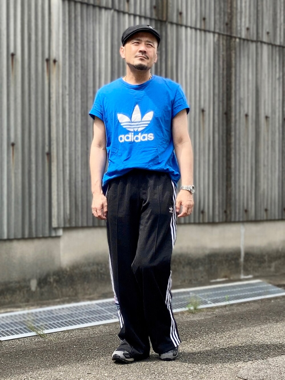 ブルー系のTシャツ/カットソー、ブラック系のスウェットパンツ、ブラック系のスニーカーを着用したメンズの夏コーディネートの3枚目の写真