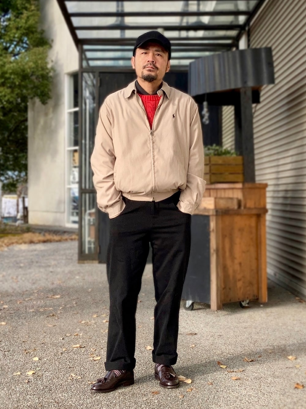 ブラック系のポロシャツ、レッド系のニット/セーター、ベージュ系のブルゾンを着用したメンズの冬コーディネートの4枚目の写真