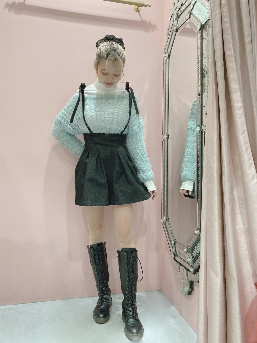 ブラック系のデニムパンツ、ブルー系のニット/セーター、ホワイト系のニット/セーターを着用したレディースの冬コーディネートの2枚目の写真