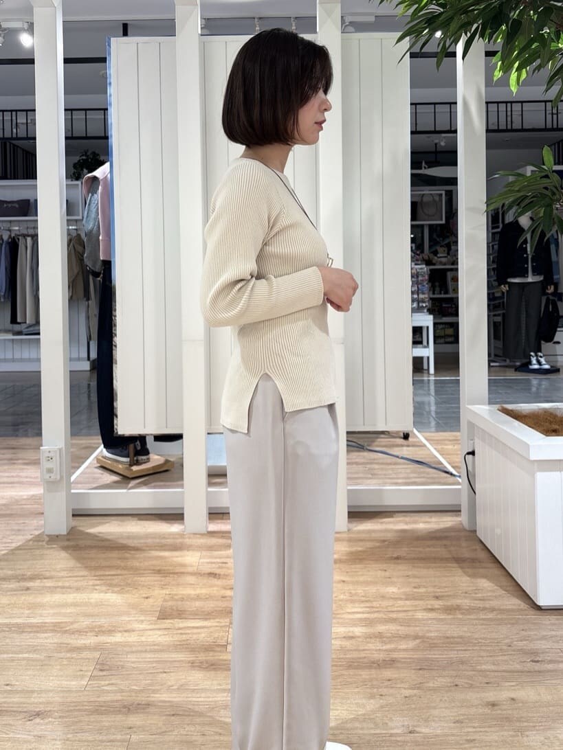 ピンク系のシャツ/ブラウス、ホワイト系のニット/セーター、ベージュ系のその他パンツを着用したレディースの春コーディネートの5枚目の写真