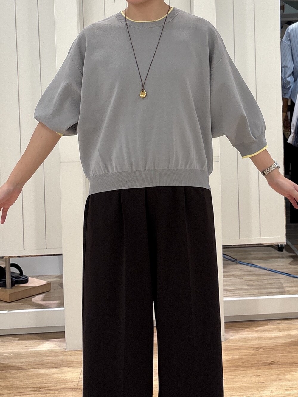 グレー系のニット/セーター、ブラウン系のその他パンツ、ブラック系のパンプスを着用したレディースの秋コーディネートの4枚目の写真