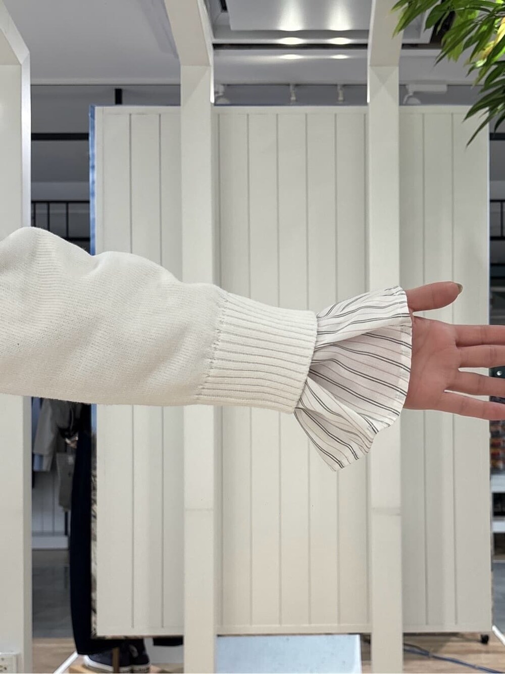 ホワイト系のニット/セーター、ピンク系のシャツ/ブラウス、ベージュ系のその他パンツを着用したレディースの春コーディネートの5枚目の写真