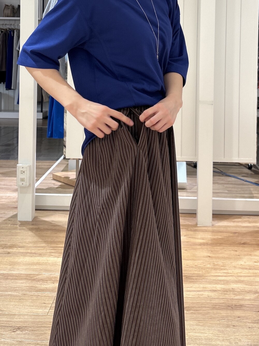 ブルー系のTシャツ/カットソー、ブラウン系のスカート、ブラック系のパンプスを着用したレディースの夏コーディネートの10枚目の写真