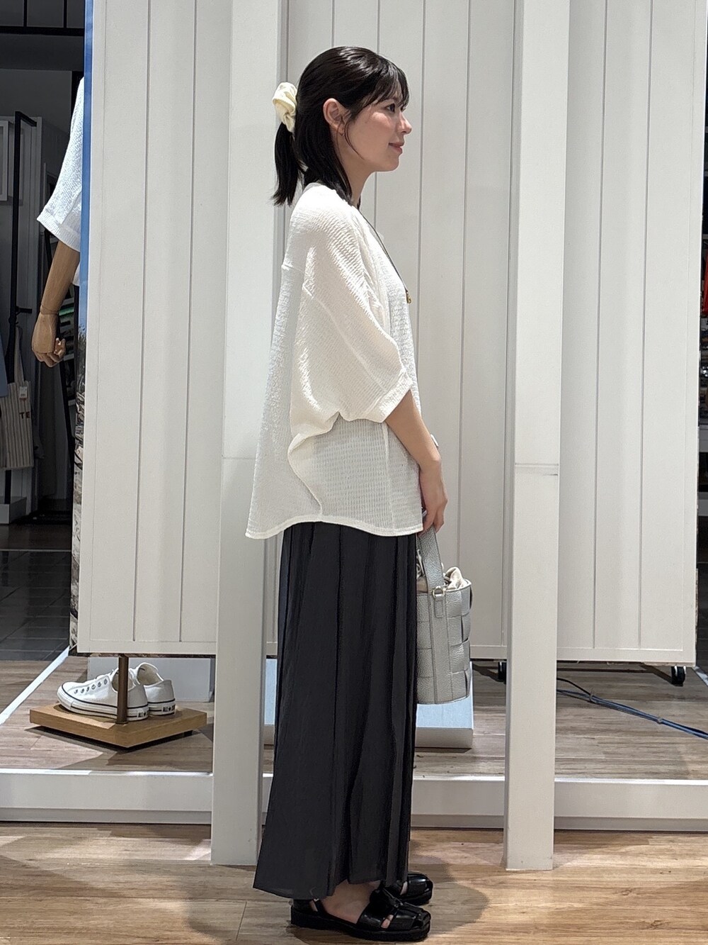 ホワイト系のTシャツ/カットソー、グレー系のその他パンツ、シルバー系のショルダーバッグを着用したレディースの夏コーディネートの2枚目の写真