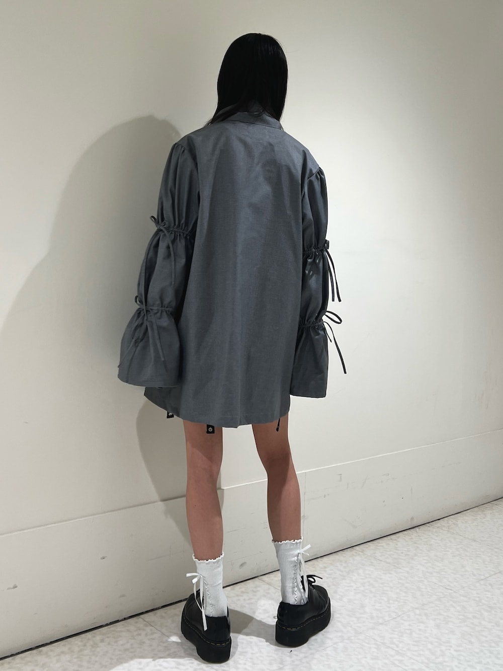 ブラック系のスカート、グレー系のワンピース、ホワイト系のシャツ/ブラウスを着用したレディースの春コーディネートの3枚目の写真