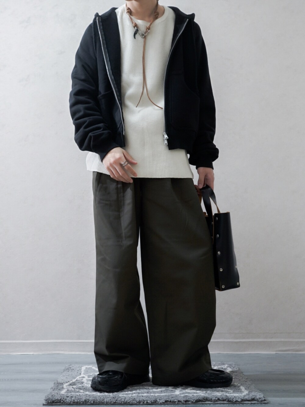 ブラック系のパーカー、ホワイト系のTシャツ/カットソー、グリーン系のその他パンツを着用したメンズの冬コーディネートの2枚目の写真