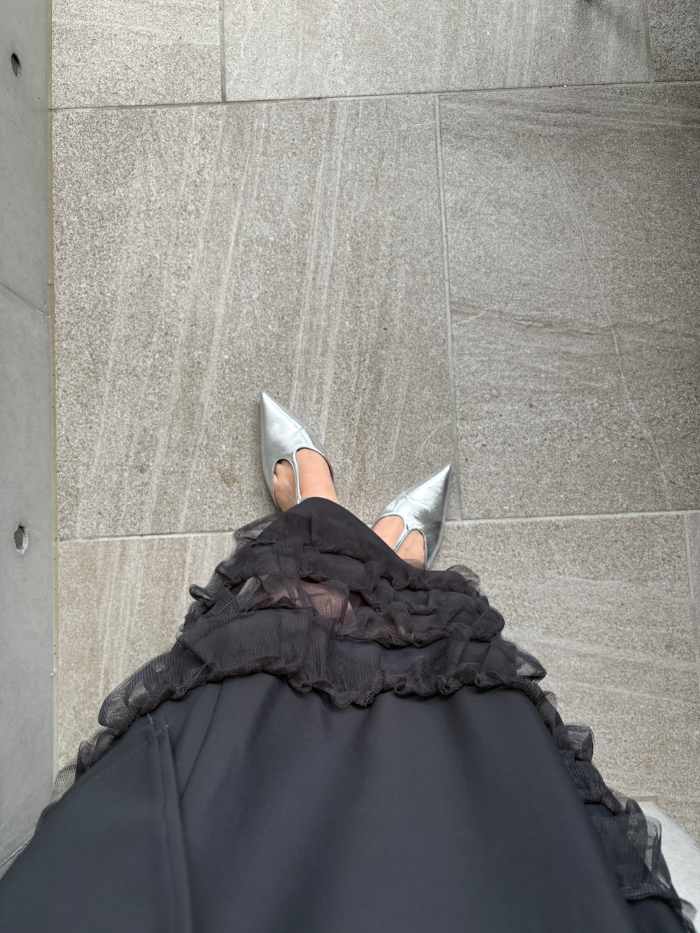 グレー系のドレス、イエロー系のショルダーバッグ、シルバー系のパンプスを着用したレディースの夏コーディネートの5枚目の写真