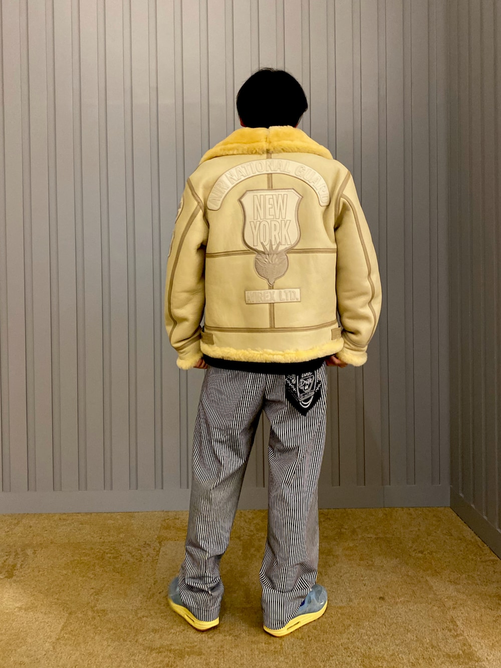 その他のチノパンツ、ホワイト系のムートンコート、ブラック系のTシャツ/カットソーを着用したメンズの夏コーディネートの2枚目の写真