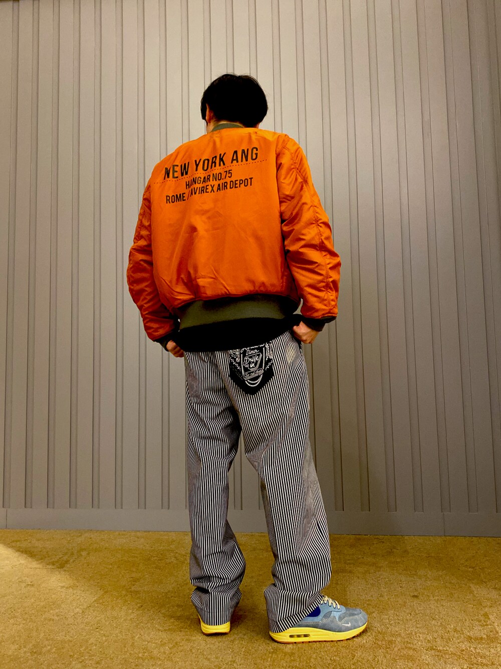 ブラック系のTシャツ/カットソー、その他のチノパンツ、グリーン系のMA-1を着用したメンズの夏コーディネートの4枚目の写真