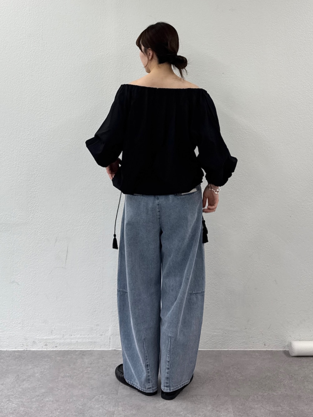 ブラック系のシャツ/ブラウス、ブルー系のデニムパンツを着用したレディースの春コーディネートの4枚目の写真