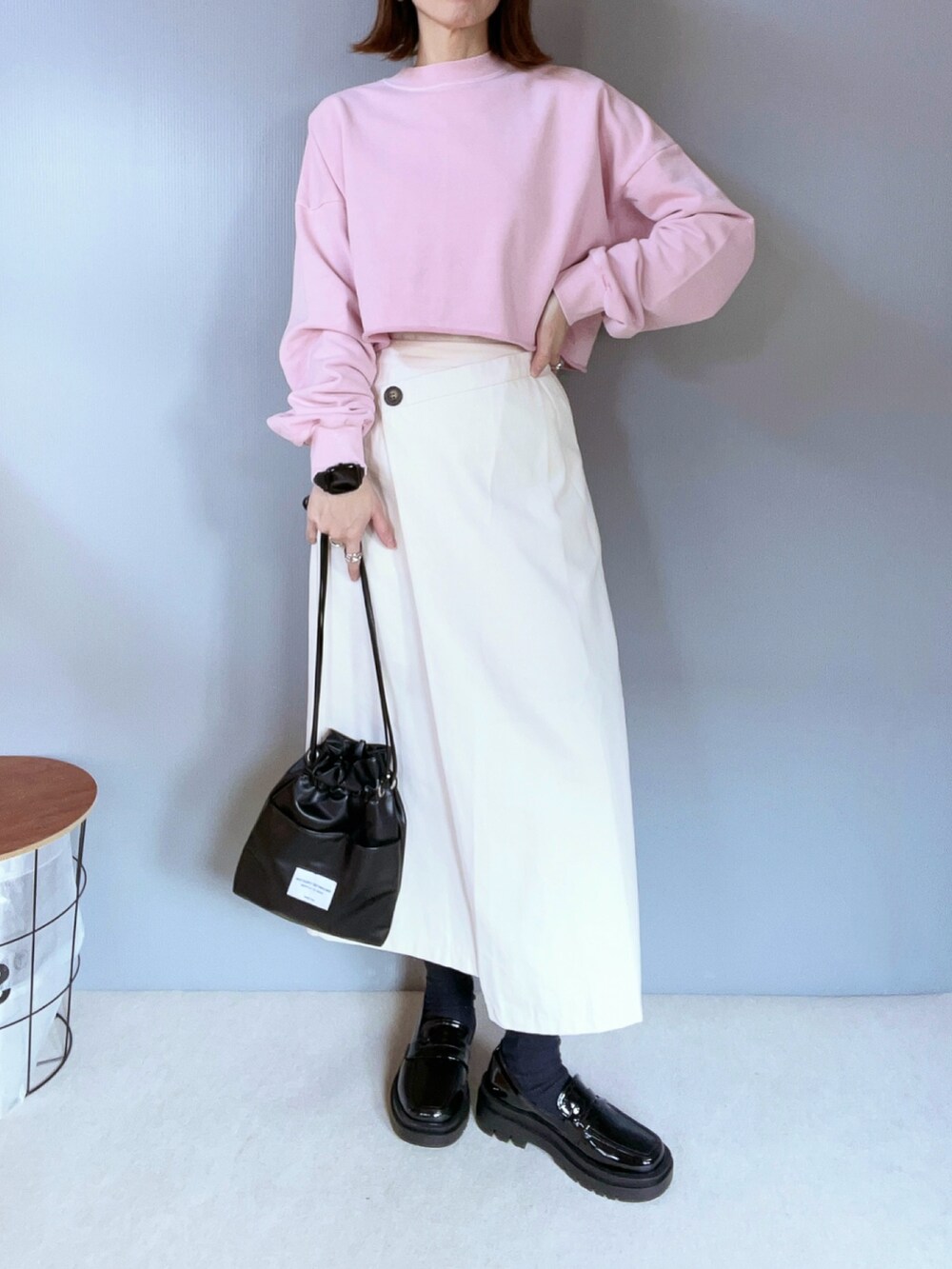 ピンク系のスウェット、ホワイト系のスカート、ブラック系のローファーを着用したレディースの冬コーディネートの3枚目の写真