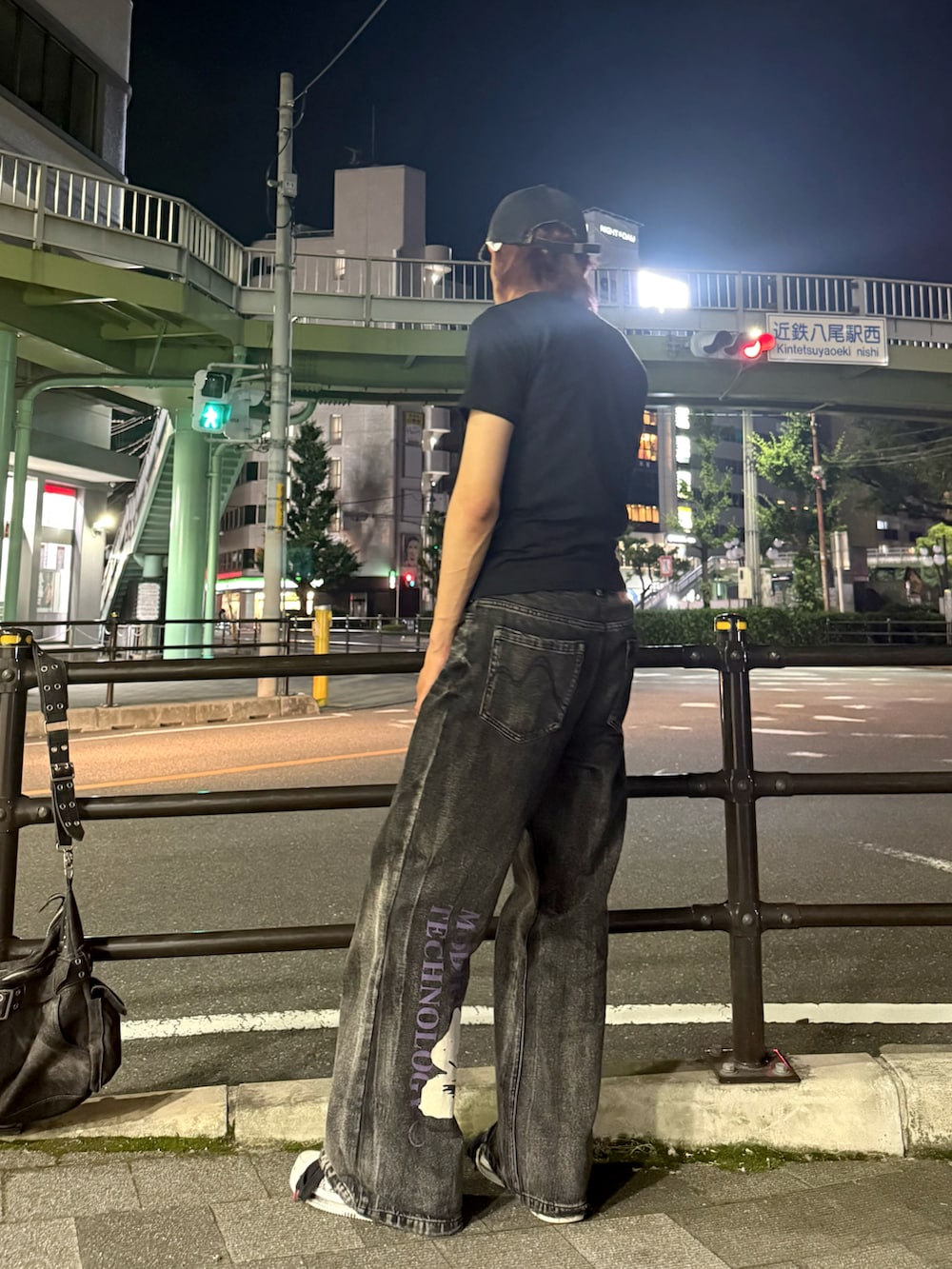 ブラック系のデニムパンツ、ブラック系のショルダーバッグ、ブラック系のTシャツ/カットソーを着用したメンズの夏コーディネートの5枚目の写真