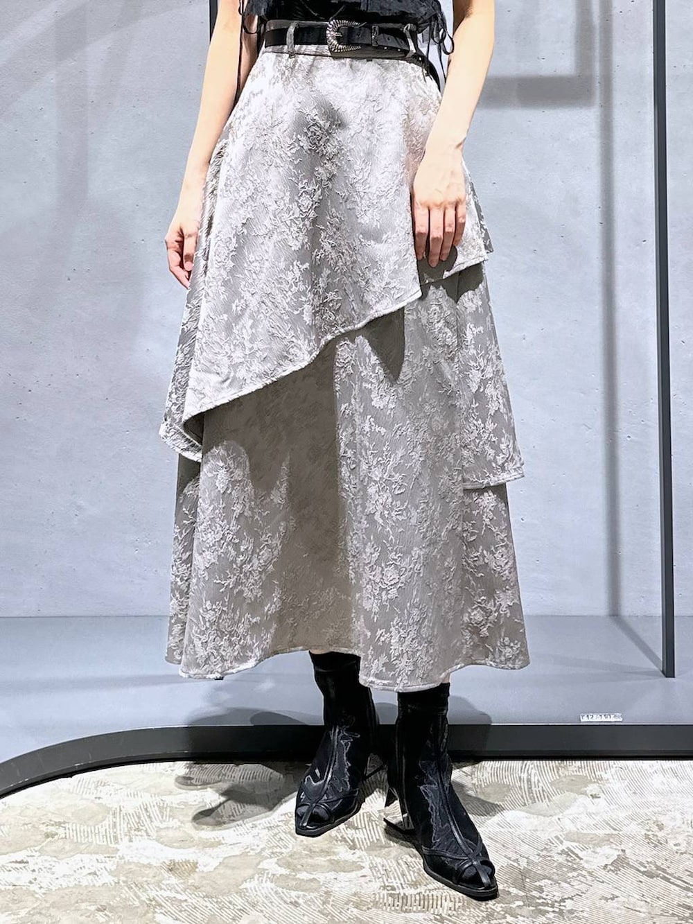 ブラック系のサンダル、ブラック系のチューブトップ、グレー系のスカートを着用したレディースの夏コーディネートの7枚目の写真