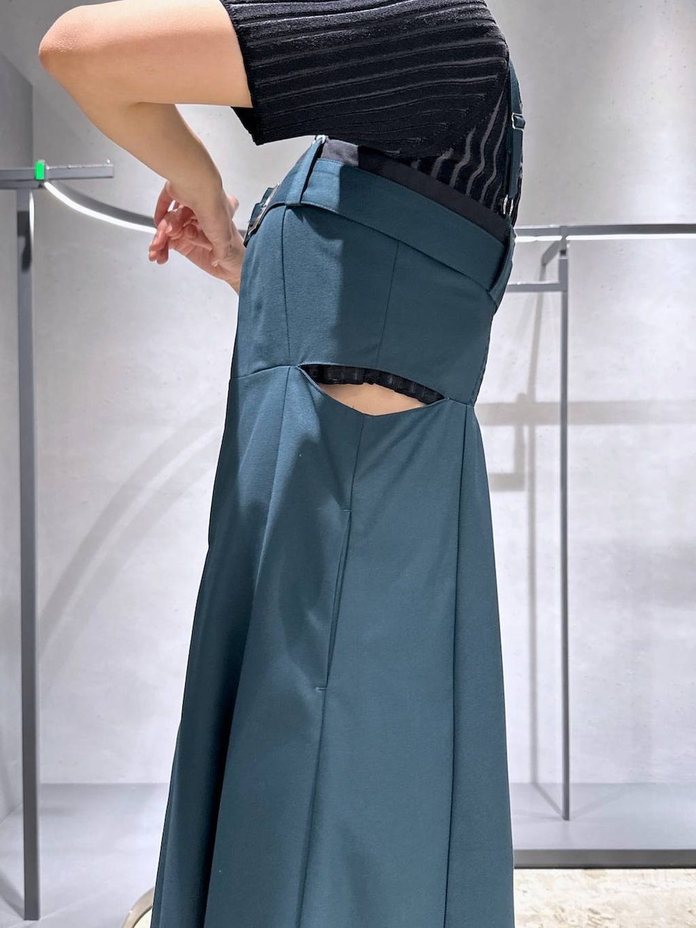 ブラック系のサンダル、グレー系のニット/セーター、グリーン系のワンピースを着用したレディースの春コーディネートの3枚目の写真