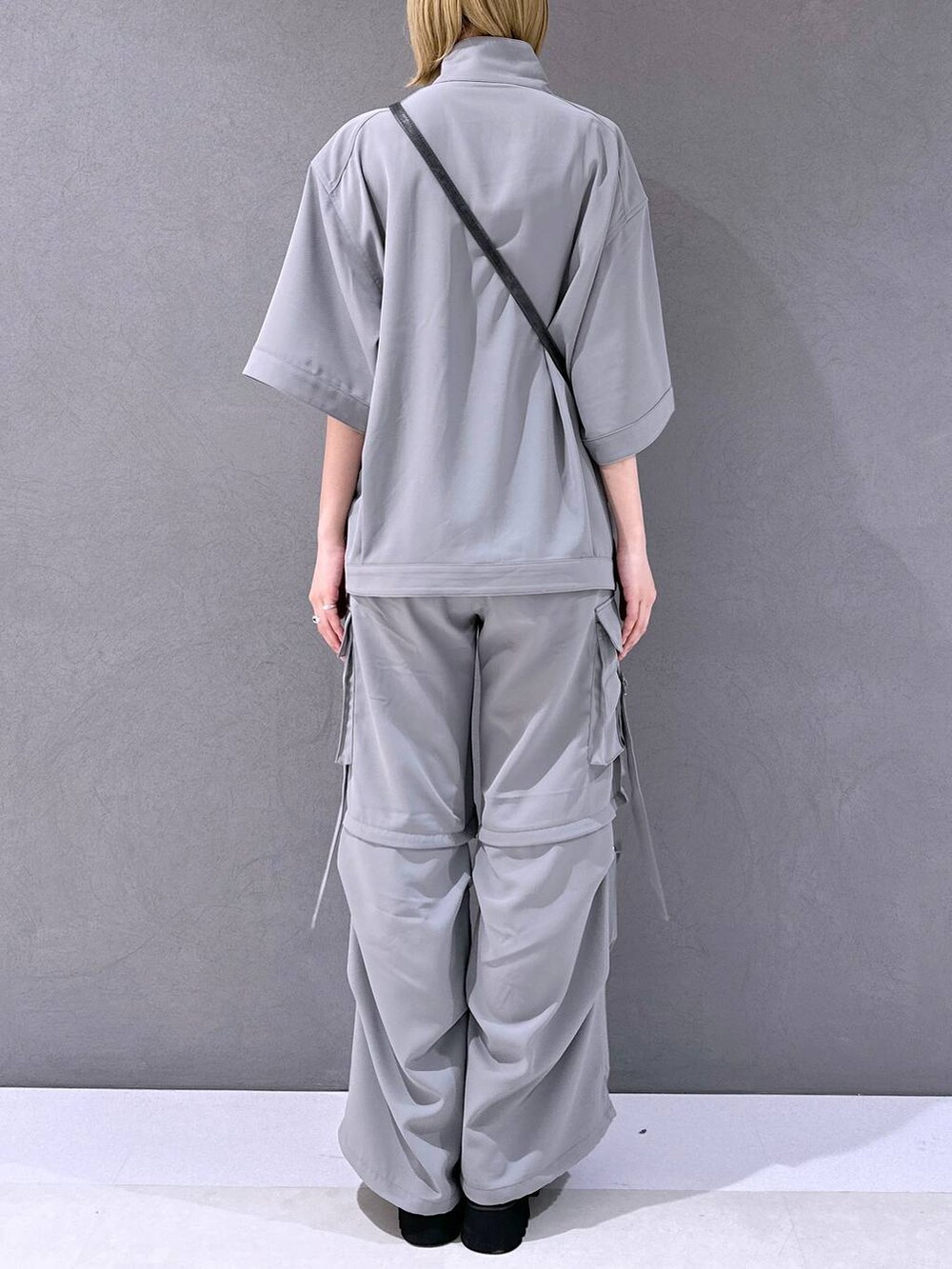 シルバー系のサンダル、グレー系のカーゴパンツ、グレー系のブルゾンを着用したレディースの春コーディネートの3枚目の写真