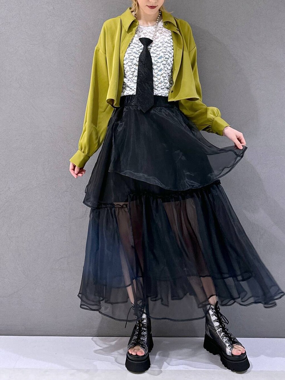 ブラック系のネクタイ、シルバー系のサンダル、イエロー系のシャツ/ブラウスを着用したレディースの春コーディネートの4枚目の写真