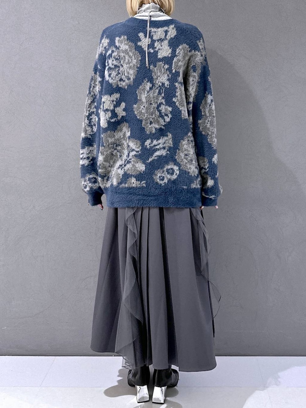 ブラック系のネクタイ、ブルー系のカーディガン/ボレロ、ブラック系のブーツを着用したレディースの秋コーディネートの3枚目の写真