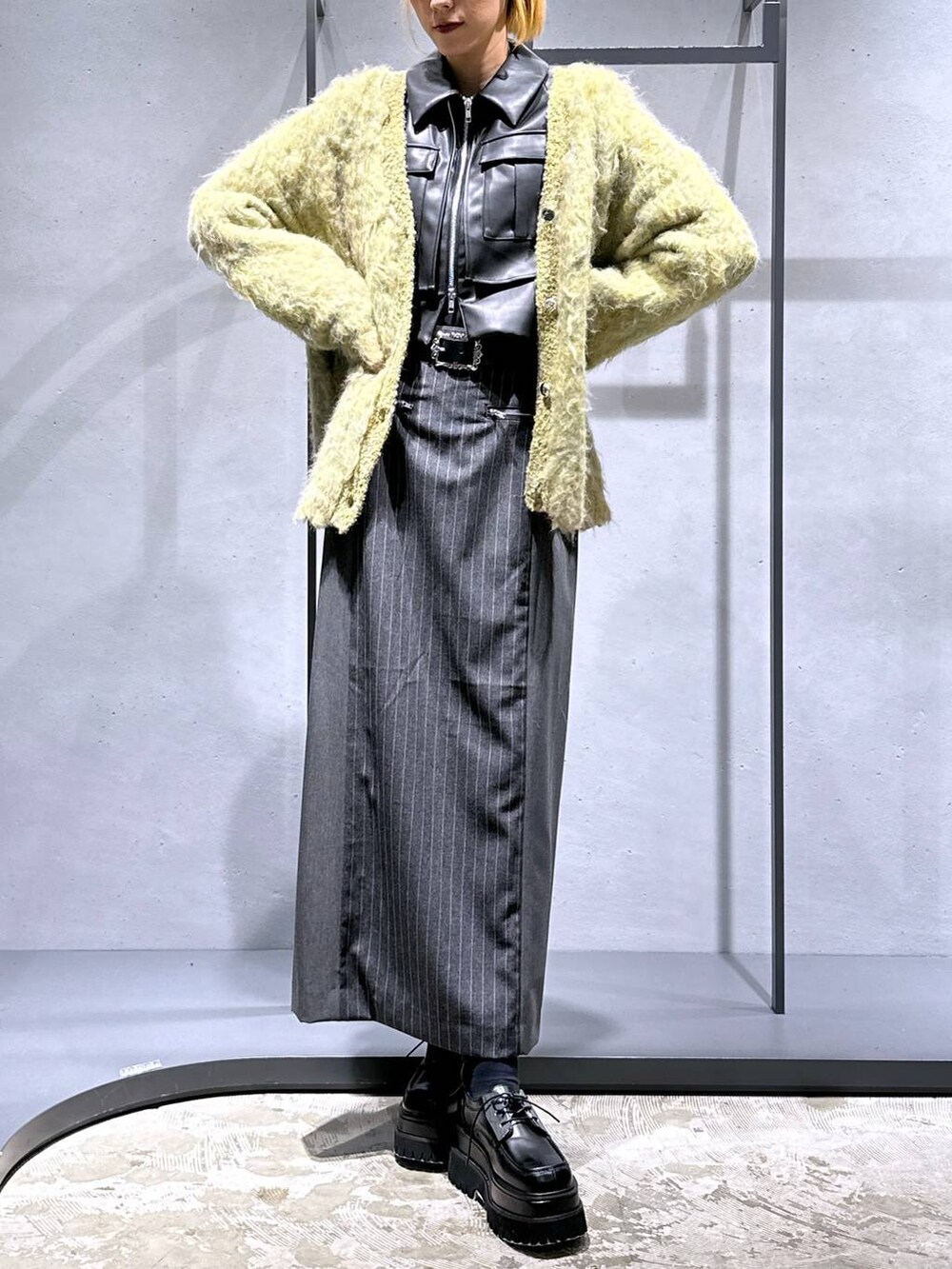 ブラック系のブルゾン、ブラック系のドレスシューズ、イエロー系のカーディガン/ボレロを着用したレディースの秋コーディネートの4枚目の写真