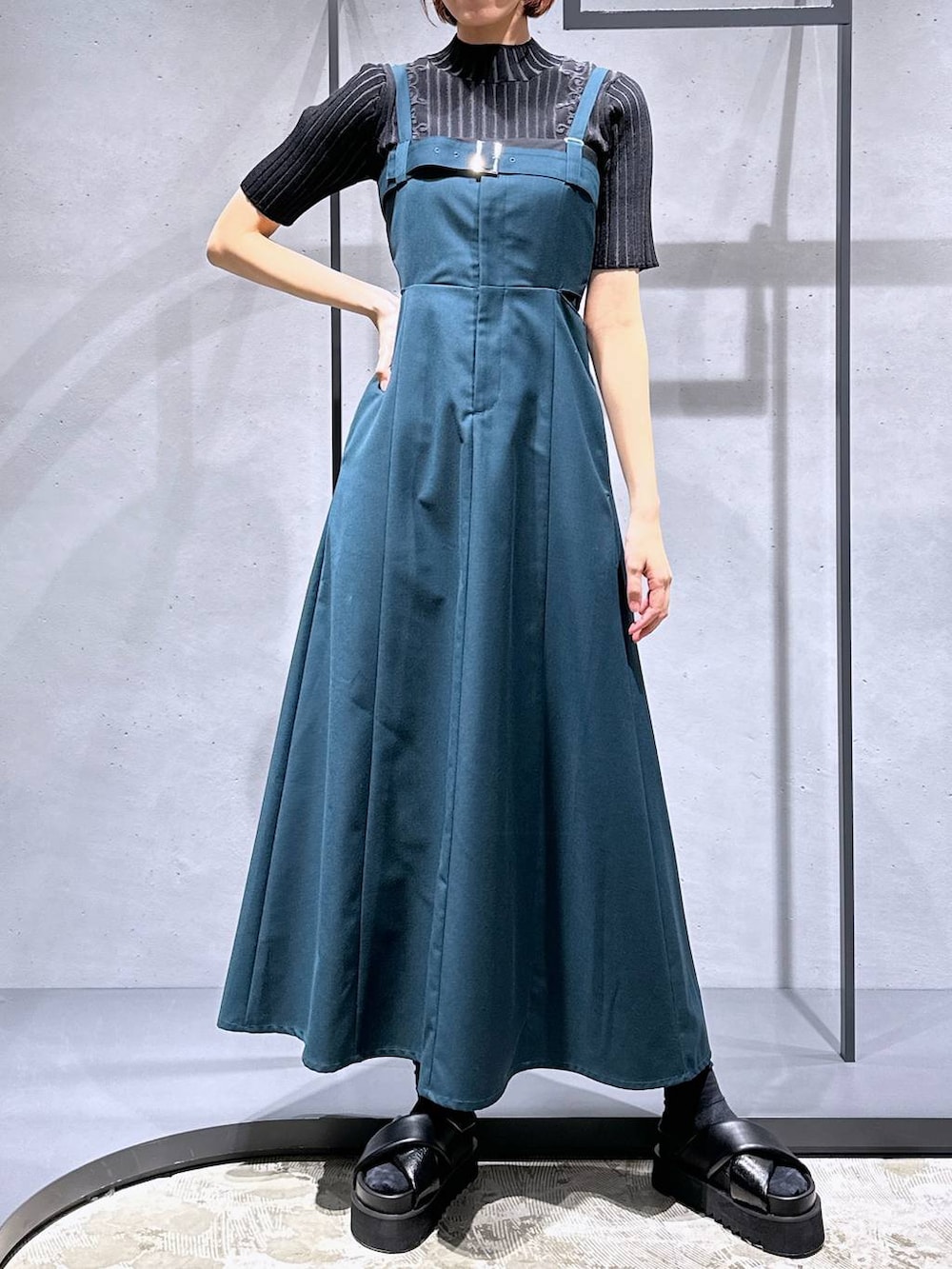 ブラック系のサンダル、グレー系のニット/セーター、グリーン系のワンピースを着用したレディースの春コーディネートの6枚目の写真