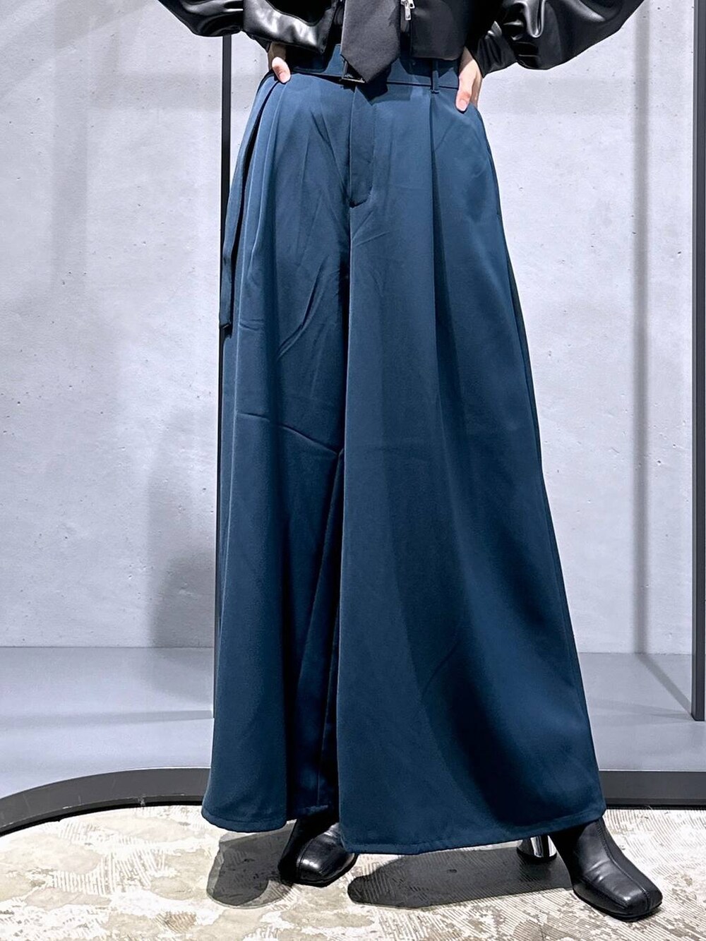 ブラック系のネクタイ、ブラック系のブーツ、グレー系のニット/セーターを着用したレディースの秋コーディネートの6枚目の写真